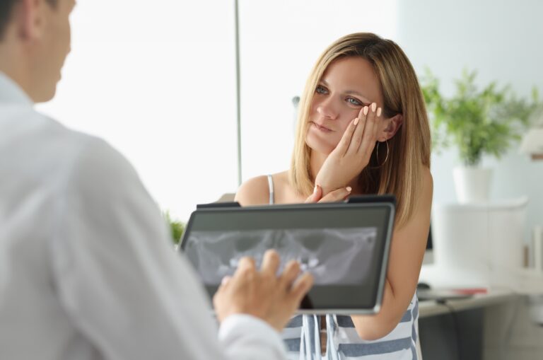 female patient in dentist office with a toothache